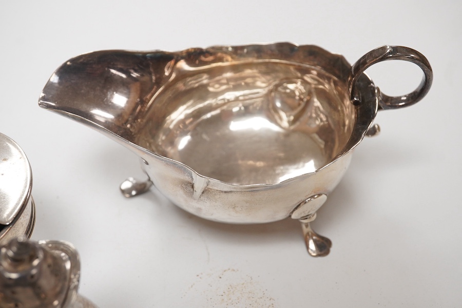 A George II provincial silver sauceboat, John Langlands I, Newcastle, 1751, a.f. and five assorted silver condiments including a George II silver pepperette, London, 1750, 11.2cm. Condition - poor to fair